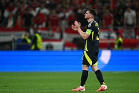 A dejected Andrew Robertson applauds at Scotland fans after the 1-0 defeat to Hungary that knocked his side out of Euro 2024. (Photo by FABRICE COFFRINI/AFP via Getty Images)