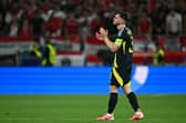 A dejected Andrew Robertson applauds at Scotland fans after the 1-0 defeat to Hungary that knocked his side out of Euro 2024. (Photo by FABRICE COFFRINI/AFP via Getty Images)