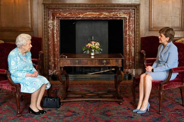 Britain's Queen Elizabeth II speaks with Scotland's First Minister Nicola Sturgeon during an audience at the Palace of Holyroodhouse in Edinburgh on June 29, 2021. (Credit: Jane Barlow/Pool/AFP)