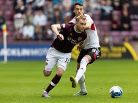 Hearts' Nathaniel Atkinson skips by Aberdeen's Bojan Miovski during Saturday's match at Tynecastle.  (Photo by Ross Parker / SNS Group)