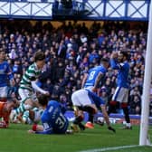 Celtic's Kyogo Furuhashi runs to grab the ball after scoring his team's late equaliser at Ibrox.
