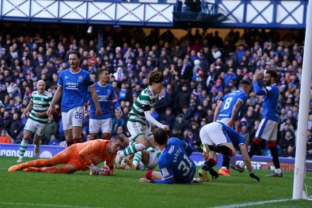 Celtic's Kyogo Furuhashi runs to grab the ball after scoring his team's late equaliser at Ibrox.