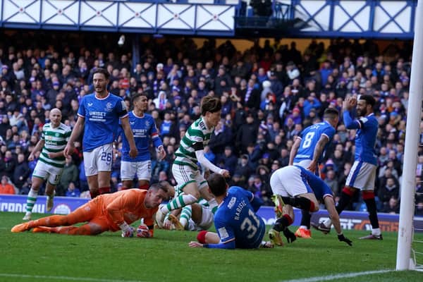 Celtic's Kyogo Furuhashi runs to grab the ball after scoring his team's late equaliser at Ibrox.