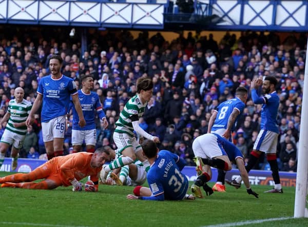 Celtic's Kyogo Furuhashi runs to grab the ball after scoring his team's late equaliser at Ibrox.