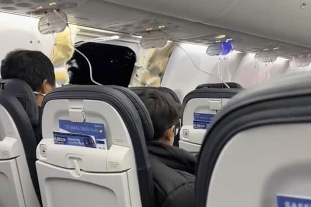 The gap left by the blown-out panel is visible in this image from video provided by Elizabeth Le from aboard the flight. (Photo by Elizabeth Le via AP)