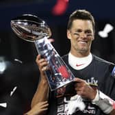 Tampa Bay Buccaneers quarterback Tom Brady (12) holds the Vince Lombardi trophy following the NFL Super Bowl 55 football game against the Kansas City Chiefs, Sunday,  (Ben Liebenberg via AP)