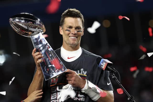 Tampa Bay Buccaneers quarterback Tom Brady (12) holds the Vince Lombardi trophy following the NFL Super Bowl 55 football game against the Kansas City Chiefs, Sunday,  (Ben Liebenberg via AP)