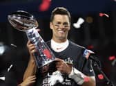 Tampa Bay Buccaneers quarterback Tom Brady (12) holds the Vince Lombardi trophy following the NFL Super Bowl 55 football game against the Kansas City Chiefs, Sunday,  (Ben Liebenberg via AP)