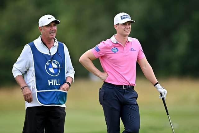 Calum Hill and experienced caddie Phil 'Wobbly' Morbey weigh up the Scot's second shot in the second round of the BMW International Open at Golfclub Munchen Eichenried. Picture; Stuart Franklin/Getty Images.