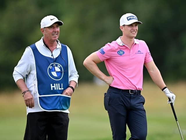 Calum Hill and experienced caddie Phil 'Wobbly' Morbey weigh up the Scot's second shot in the second round of the BMW International Open at Golfclub Munchen Eichenried. Picture; Stuart Franklin/Getty Images.