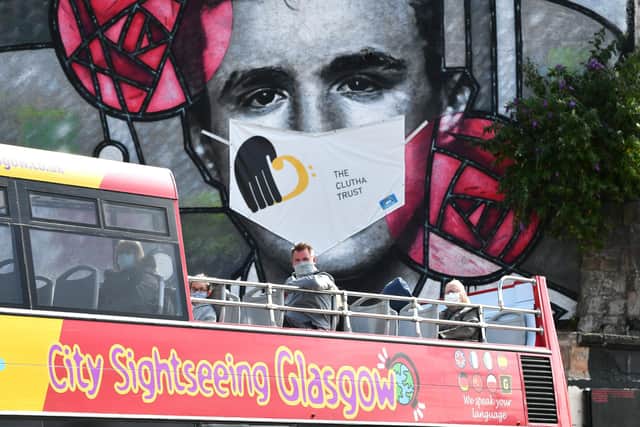 A giant mural of Charles Rennie Mackintosh outside Glasgow’s Clutha Bar has been fitted with the £250 covering. Picture: John Devlin