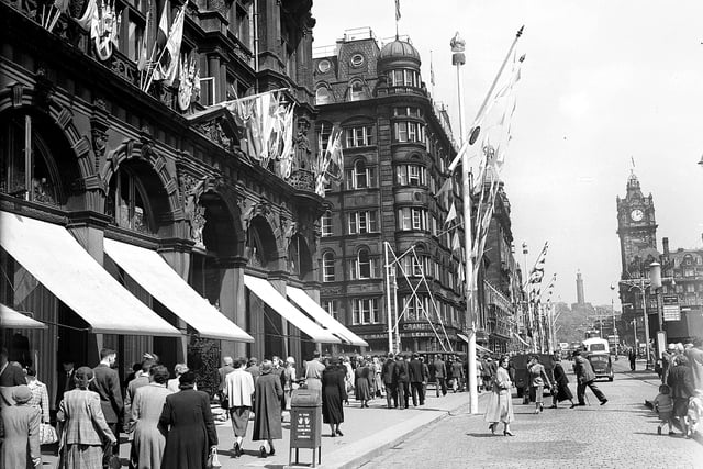 In honour of Queen Elizabeth II visiting Edinburgh, coronation decorations adorn the East End of Princes Street, including the famous department store. Year: 1953