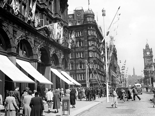 In honour of Queen Elizabeth II visiting Edinburgh, coronation decorations adorn the East End of Princes Street, including the famous department store. Year: 1953