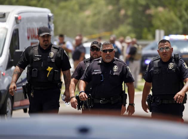 Police walk near Robb Elementary School following a shooting in Uvalde, Texas. (AP)