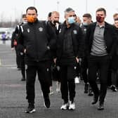 Motherwell's players walk over after arriving in their cars at Celtic Park