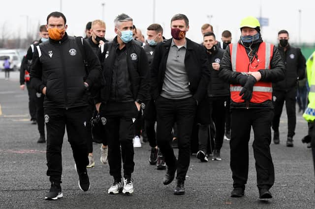 Motherwell's players walk over after arriving in their cars at Celtic Park