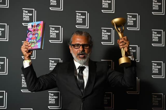 Shehan Karunatilaka holding the Booker Prize 2022 award for his second novel ‘The Seven Moons of Maali Almeida’.