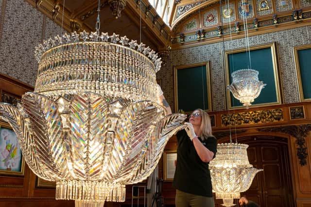 Chandeliers in the Waterloo Chamber at Windsor Castle are given a final check and polish in preparation for the room's reopening to visitors on Saturday April 9 following renovation works.