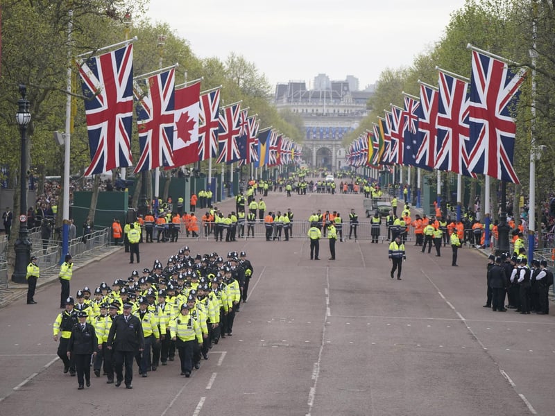 Metropolitan Police officers march along The Mall in London as they head to their positions for of the coronation processions of King Charles III and Queen Camilla.