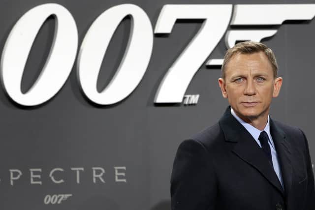 FILE - In this Oct. 28, 2015, file photo, actor Daniel Craig poses for the media as he arrives for the German premiere of the James Bond movie 'Spectre' in Berlin, Germany.   Amazon, on Wednesday, May 26, 2021,  is buying MGM, the movie and TV studio behind James Bond with the hopes of filling its video streaming service with more stuff to watch.  (AP Photo/Michael Sohn, File)