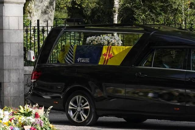 The hearse carrying the coffin of Queen Elizabeth II, draped with the Royal Standard of Scotland, leaving Balmoral as it begins its journey to Edinburgh. Picture date: Sunday September 11, 2022.