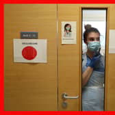 Staff nurse Aria Blyth communicates using walkie talkies from a Covid area to the ward A31 at Forth Valley Royal Hospital in Larbert. Picture: Andrew Milligan/PA Wire