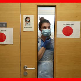 Staff nurse Aria Blyth communicates using walkie talkies from a Covid area to the ward A31 at Forth Valley Royal Hospital in Larbert. Picture: Andrew Milligan/PA Wire