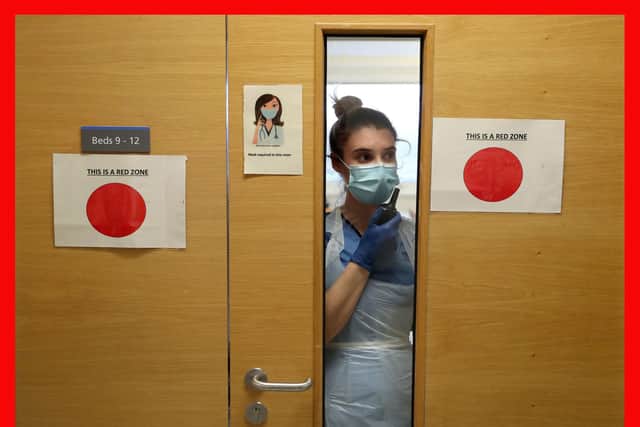 Staff nurse Aria Blyth communicates using walkie talkies from a Covid area to the ward A31 at Forth Valley Royal Hospital in Larbert. Picture: Andrew Milligan/PA Wire