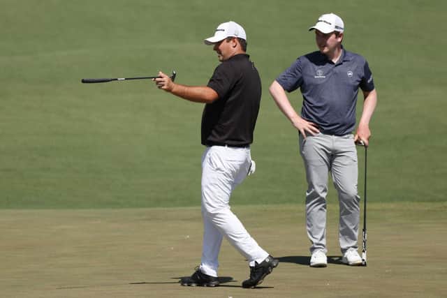 Patrick Reed, the 2018 winner, offers some advice to Bob MacIntyre on the second green during a Masters practice round on Monday at Augusta National Golf Club. Picture: Kevin C. Cox/Getty Images.