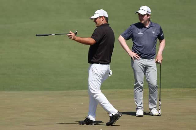 Patrick Reed, the 2018 winner, offers some advice to Bob MacIntyre on the second green during a Masters practice round on Monday at Augusta National Golf Club. Picture: Kevin C. Cox/Getty Images.
