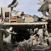 Palestinian youths search the rubble of a building hit in overnight Israeli bombardment in Rafah in the southern Gaza Strip.