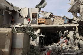 Palestinian youths search the rubble of a building hit in overnight Israeli bombardment in Rafah in the southern Gaza Strip.