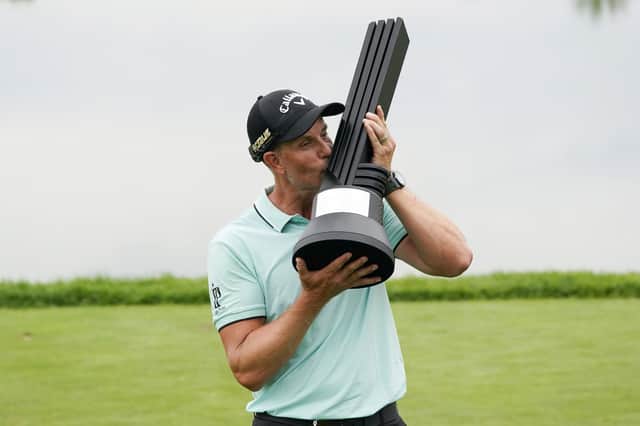 Henrik Stenson, of Sweden, kisses the trophy after winning the individual competition of the LIV Golf Invitational at Trump National in Bedminster.