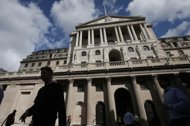 Pedestrians walk past the main entrance of The Bank of England in the City of London. Britain’s big banks can deal with a shock far worse than the economic fallout caused by the pandemic and still continue to lend, the Bank of England believes. Picture: Daniel Leal-Olivas/AFP/Getty Images
