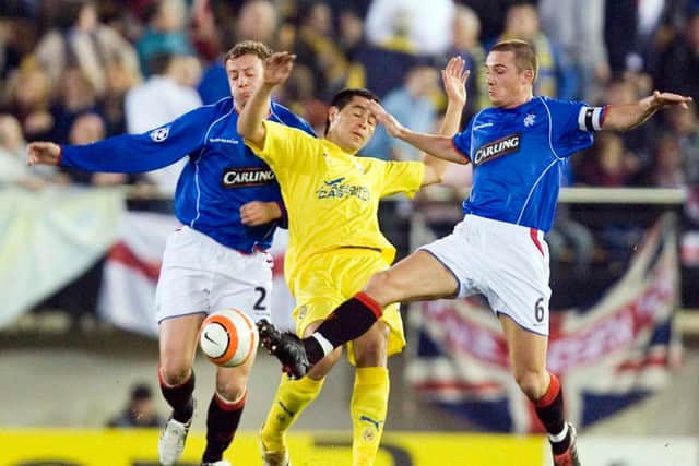 Alan Hutton (left) and Barry Ferguson (right) squeeze out Villarreal dangerman Juan Roman Riquelme in the side's last 16 Champions League clash to which Alex McLeish guided them. The former Ibrox manager believes financial disparities make it almost "impossible" to believe the club can again make it beyond the Champions League group stages. (Photo by Alan Harvey/SNS Group).