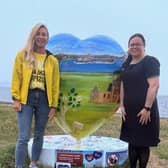 Karen Duff (L) from Highland Hospice and Andrea Farrelly (R) from Specsavers in front of the heart artwork