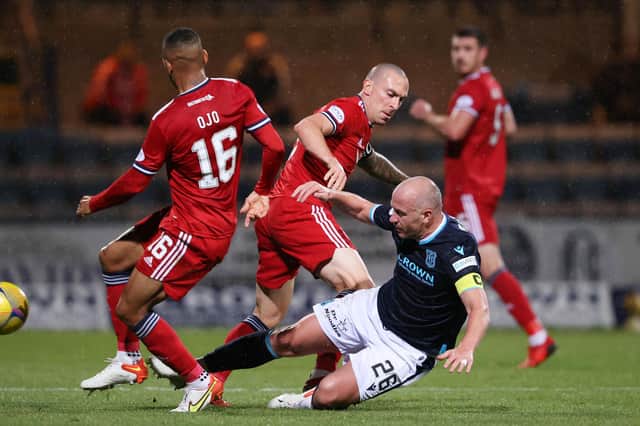 Dundee skipper Charlie Adam (right) tackles opposite number Scott Brown during the Dens Park side's 2-1 win over Aberdeen on Saturday night (Photo by Alan Harvey / SNS Group)