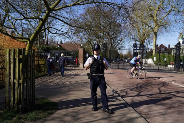 A policeman at the gates of Richmond Park the day after Prime Minister Boris Johnson put the UK in lockdown to help curb the spread of the coronavirus. PA Photo.