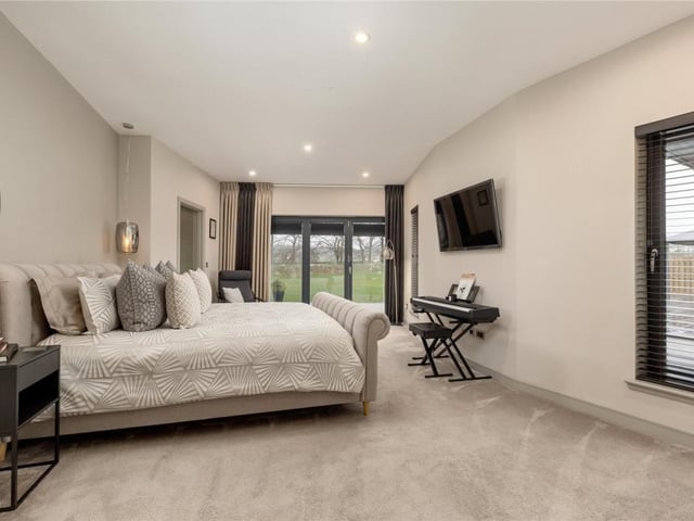 The principal bedroom overlooks the garden and features a centrally located en-suite accessed by two fitted dressing rooms.