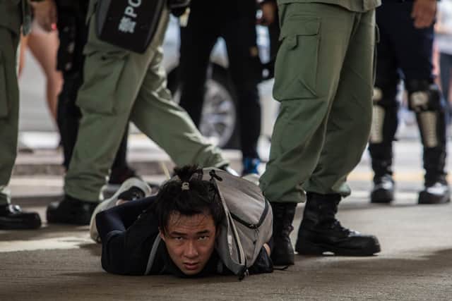Riot police detain a man as they clear protesters taking part in a rally against a new national security law in Hong Kong on July 1, 2020, on the 23rd anniversary of the city's handover from Britain to China.