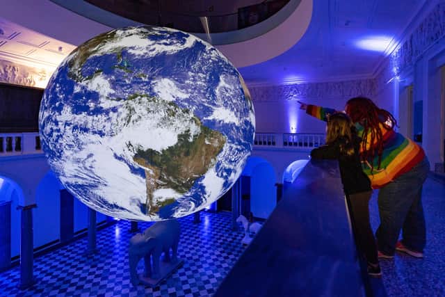 Luke Jerram's Gaia suspends in Aberdeen Art Gallery. The seven-foot wide model of Earth was created using NASA data and aims to replicate the profound feelings experienced by astronauts as they look back towards the planet. PIC: Ian Georgeson.