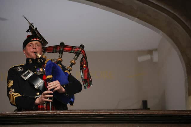 A piper from the Royal Regiment of Scotland plays on the day of the state funeral and burial of Britain's Queen Elizabeth, at Westminster Abbey in London. Picture: Phil Noble/AFP via Getty Images