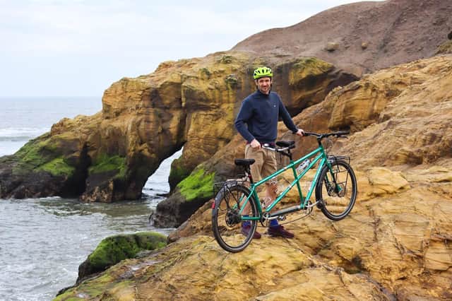Xani and his tandem posing on cliff