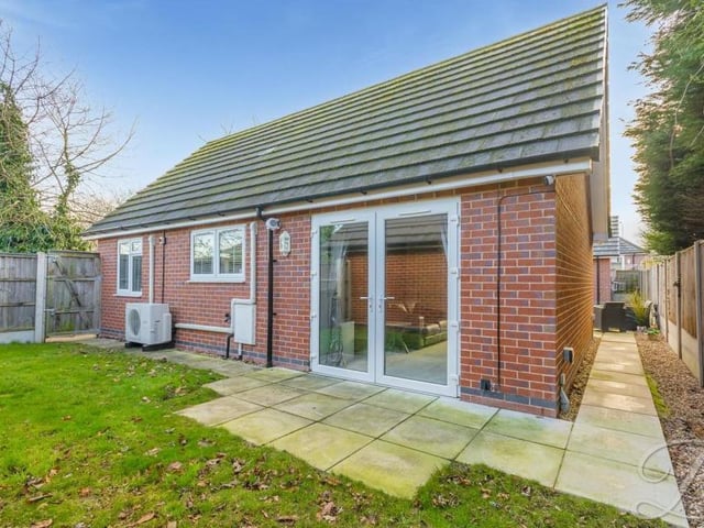 Moving outside now, and this is a view from the back of the bungalow. The large patio doors lead out from the open-plan hub.