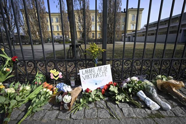 Bouquets of flowers lie outside the Malmo Latin School on March 22, 2022 in Malmoe, Sweden, a day after two women were killed. - Police in Sweden were attempting to determine why an 18-year-old student allegedly killed two teachers at a high school a day earlier in an attack that has shaken the country. Photo by JOHAN NILSSON/TT NEWS AGENCY/AFP via Getty Images
