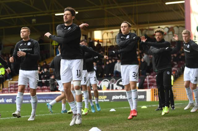 The Hibs team warm up before the Scottish Cup tie with Motherwell at Fir Park. Picture: SNS