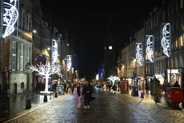 People on the near deserted Royal Mile in Edinburgh after all outdoor events including the street party and fireworks display planned for Edinburgh's Hogmanay festival were cancelled due to bad weather.
