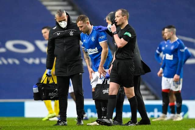 Scott Arfield leaves the field with an injury six minutes after replacing Ianis Hagi (Photo by Rob Casey / SNS Group)