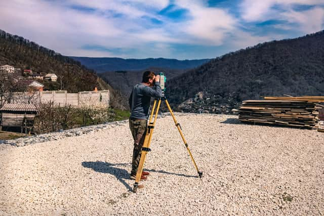 A surveyor looks out over geological formations as part of research work.