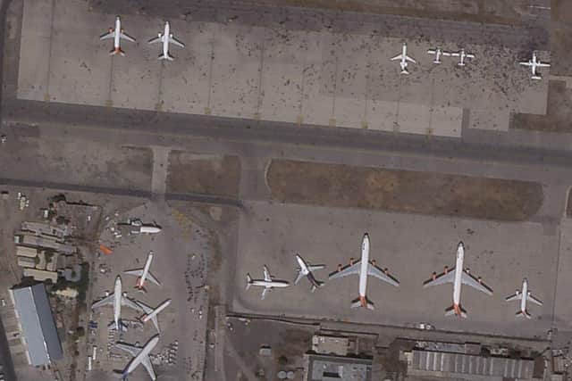 This satellite photo from Planet Labs Inc. shows swarms of people on the tarmac at Kabul International Airport. Picture: Planet Labs Inc. via AP